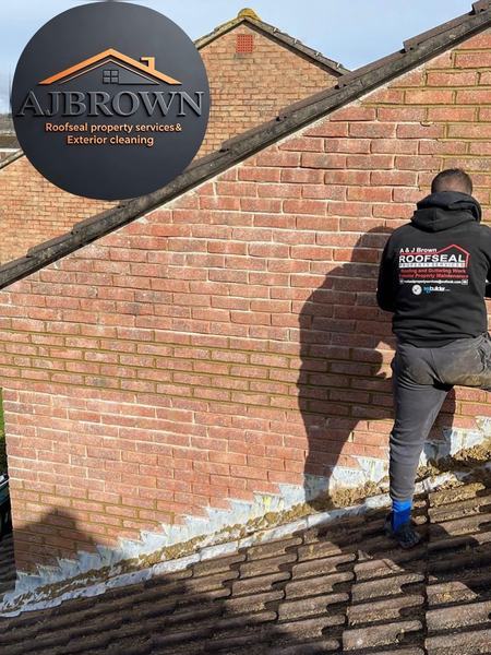 ROOF2ROOF Solutions Ltd team member repointing brickwork and lead flashing on roof