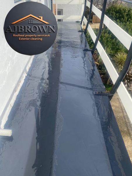 Freshly applied roof sealant on flat roof walkway